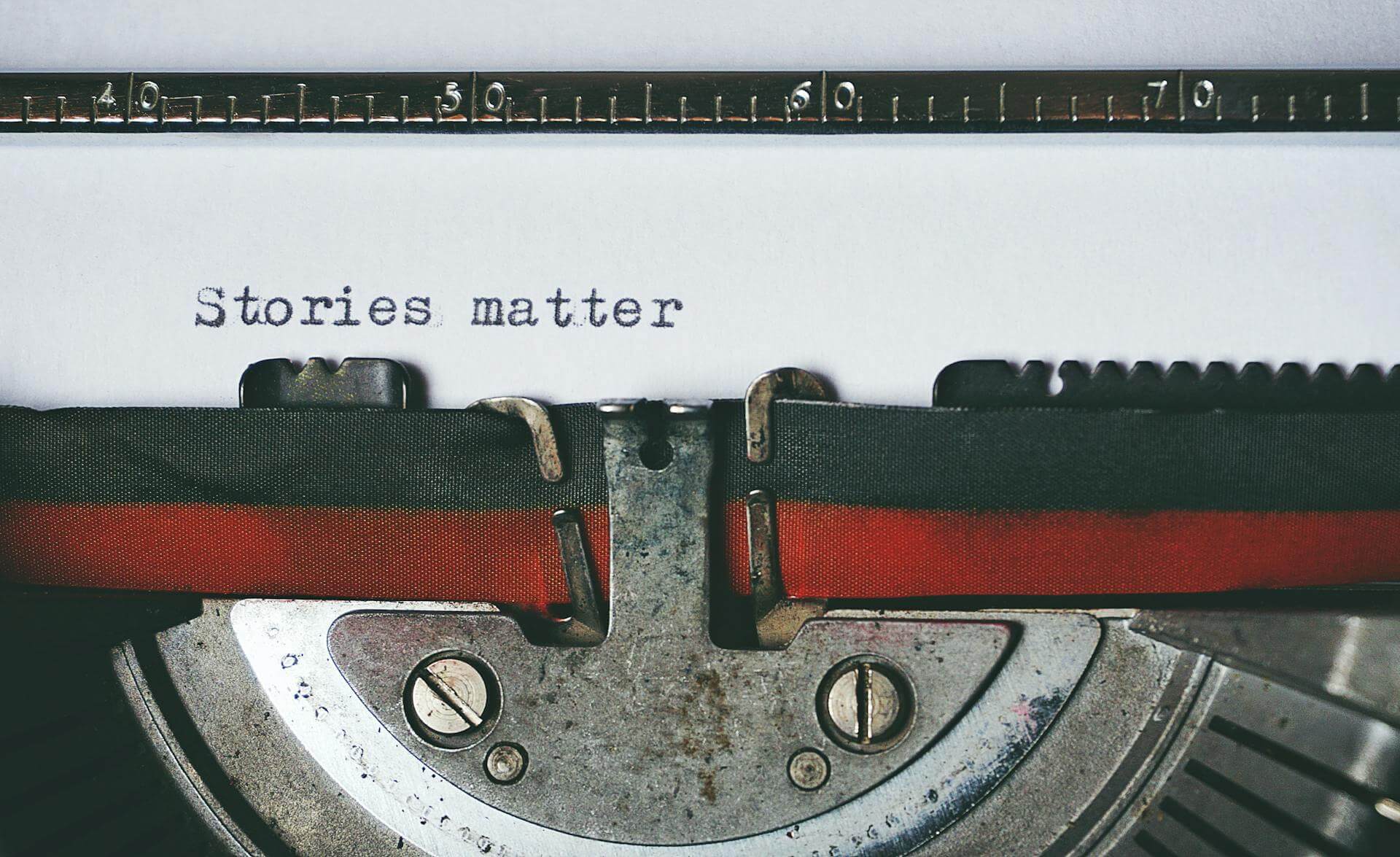 Paper in typewriter reads 'Stories Matter'
